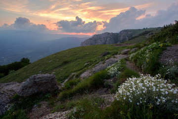 sunset in the mountains of flowers, stones and sun