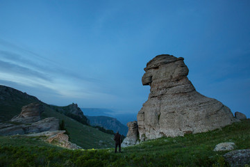 Twilight in the mountains, People against the backdrop of bizarre mountains
