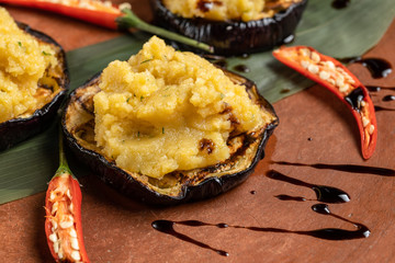 Pumpkin puree is laid out on grilled eggplant.