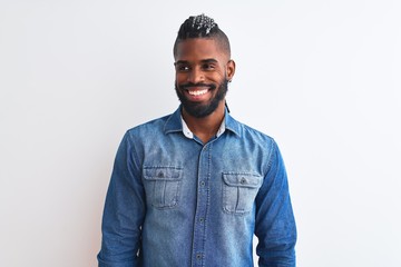 African american man with braids wearing denim shirt over isolated white background looking away to side with smile on face, natural expression. Laughing confident.