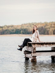 Fototapeta premium woman sitting on pier