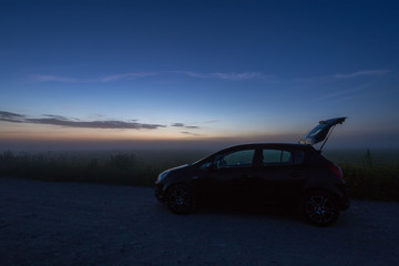 Fototapeta na wymiar car in the night in the field, backlight