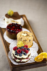 berry cake, lemon cake, cheesecake, desserts on a tray