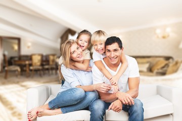 Young  family at home smiling at camera