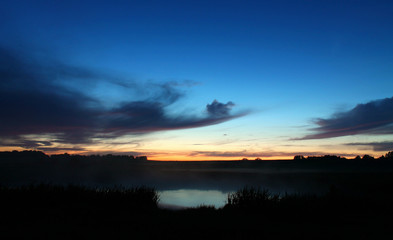 Lake after sunset, grass, backlit