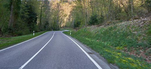 Dynamic shot of a road with bends through a forest in Germany, Schwarzwald