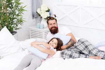 Obraz na płótnie Canvas we are one. family bonding time. Relax sweetie. i love my daddy. happy morning together. funny pajama party. small girl with bearded father in bed. weekend at home. father and daughter having fun