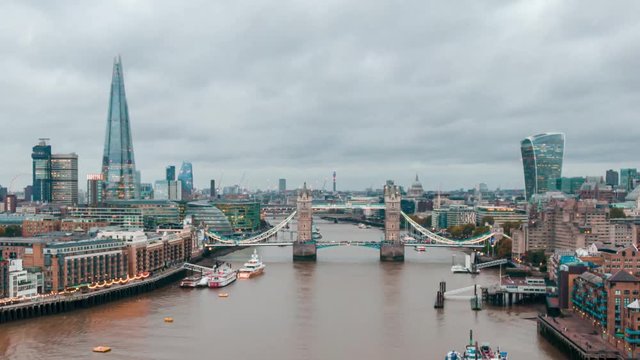 Aerial Drone Hyperlapse Helicopter Cloudy View Of Tower Bridge London City Skyline The Shard Sky Garden And Thames River Time Lapse Clouds Moving