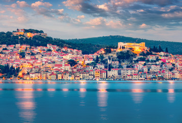Fototapeta na wymiar Colorful evening cityscape of Sibenik city. Great summer seascape of Adriatic sea, Croatia, Europe. Beautiful world of Mediterranean countries. Traveling concept background.