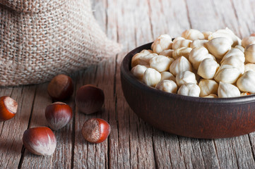 Hazelnuts, filbert in bowl on wooden table. heap or stack of hazel nuts. Hazelnut background,...
