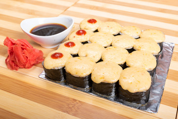 A large set of baked rolls with cheese caps.