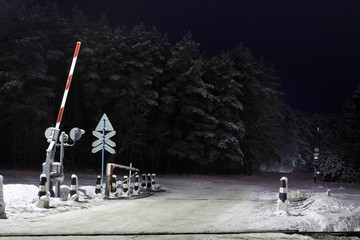 railway crossing in winter at night
