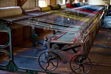 Fototapeta na wymiar colored woolen threads on an old loom, Traditional Yarn in Canada.
