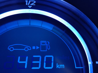Fuel economy gauge with glowing digital technology indication of mileage remaining to refueling....