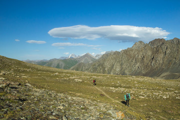 Fototapeta na wymiar trekking in the mountains, people with backpacks, tian shan, Kyrgyzstan