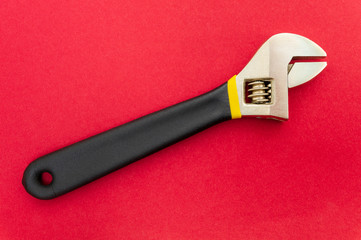 Obraz premium New adjustable spanner on a red background