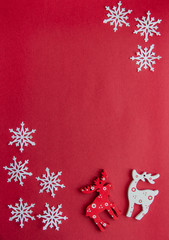 white deer and snowflakes on a red background. Merry Christmas and Happy New Year greeting card. Copy space.