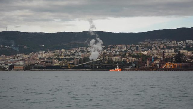 Industrial zone in Trieste city over bay seen from Muggia, Italy