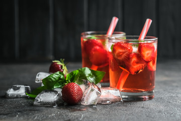 Homemade strawberry lemonade with basil on a dark background.