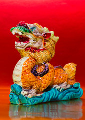 Fototapeta na wymiar The symbol of the Chinese horoscope, the dragon statue on red background