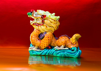 The symbol of the Chinese horoscope, the dragon statue on red background