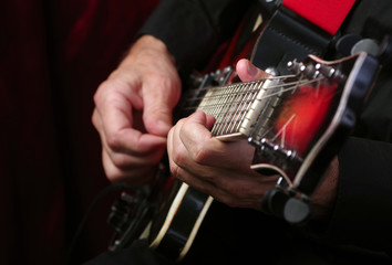 Guitarist hands and guitar close up. playing electric guitar.