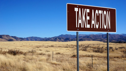 Take action word on road sign