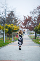 Beautiful girl in a dress on a city alley