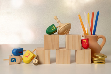 concept of of jewish religious holiday hanukkah with wooden spinning top toys (dreidel), wooden...