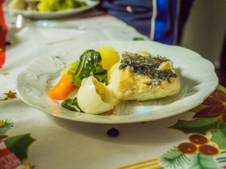 codfish with mashed potatos, spinach and eggs on white plate. Traditional portuguese crhistmas night food