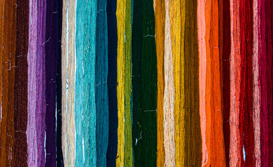 Colorful rainbow of freshly hand dyed yarn hanging on a wall - obrazy, fototapety, plakaty