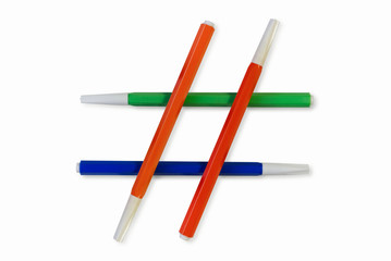 Hashtag education. School stationery. Isolated on white background multicolored felt pens lie in the form of a hashtag sign.