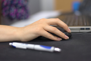 Businesswoman Working Alone On Laptop In her Office. Beautiful business woman using a laptop computer at office. Businesswoman busy working on her laptop.