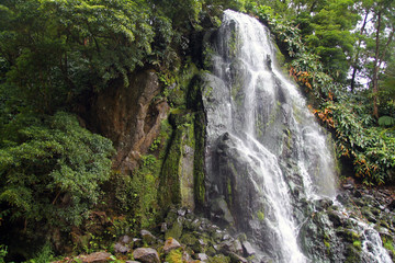 Fototapeta na wymiar Impressing waterfall in the green nature of Azores islands