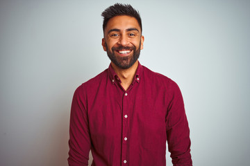 Young indian man wearing red elegant shirt standing over isolated grey background with a happy and cool smile on face. Lucky person. - Powered by Adobe
