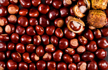 Background of peeled and unpeeled chestnuts. Top view.