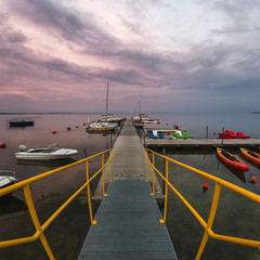boats moored to the dock after sunset