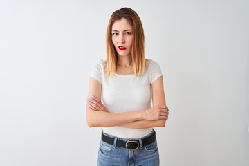 Beautiful redhead woman wearing casual t-shirt standing over isolated white background skeptic and...
