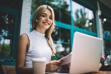 Smiling freelancer with notebook looking at camera