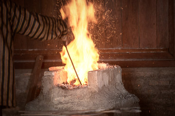 Blacksmith heat up the molten metal to make keris