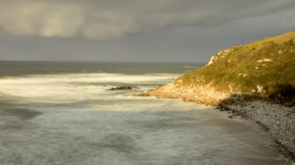 Waves beating against the rocks at Vidiago beach in Asturias