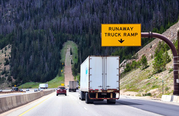 Runaway truck ramp alongside a steep downhill highway in the mountains