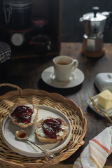 Breakfast, steaming coffee, toasted bread with butter and marmalade