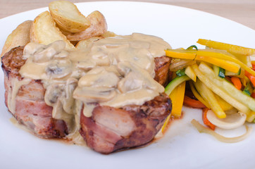 meat in mushroom sauce salad and potatoes