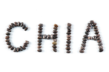 Word "CHIA" made of chia seeds isolated on a white background.