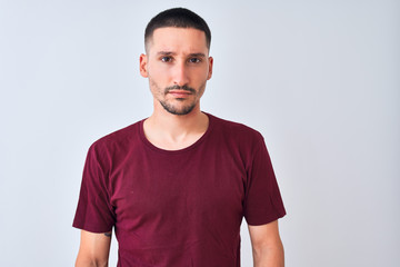 Fototapeta premium Young handsome man standing over isolated background skeptic and nervous, frowning upset because of problem. Negative person.
