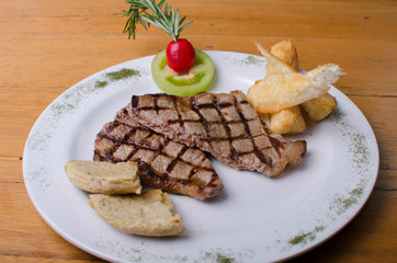 grilled meat accompanied by salad and potato