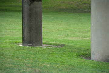 grassy area with large cement pillars