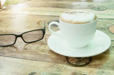 cup of coffee on wooden table
