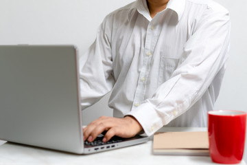 Businessman working at home office with laptop and documents on his desk, start-up business concept.